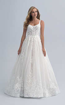A woman wearing a wedding dress with a square neckline with a flowered bodice and flowers extending through the skirt
