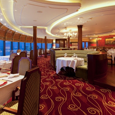 Dining room at Palo restaurant with Italian-inspired decor, banquette seating and floor to ceiling windows