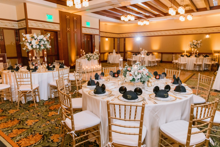 venue shot, decorated venue, wedding reception, reception, table rounds, custom chairs, chiavari chairs, wedding favors, mickey hats, uplighting, custom uplighting, reception decor, custom centerpieces, table centerpieces