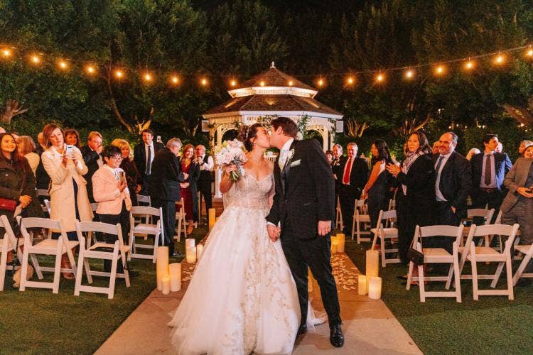bride and groom, couple, exit, wedding ceremony, ceremony, ceremony exit, kiss, rose court, rose court garden, Disneyland, Disneyland hotel