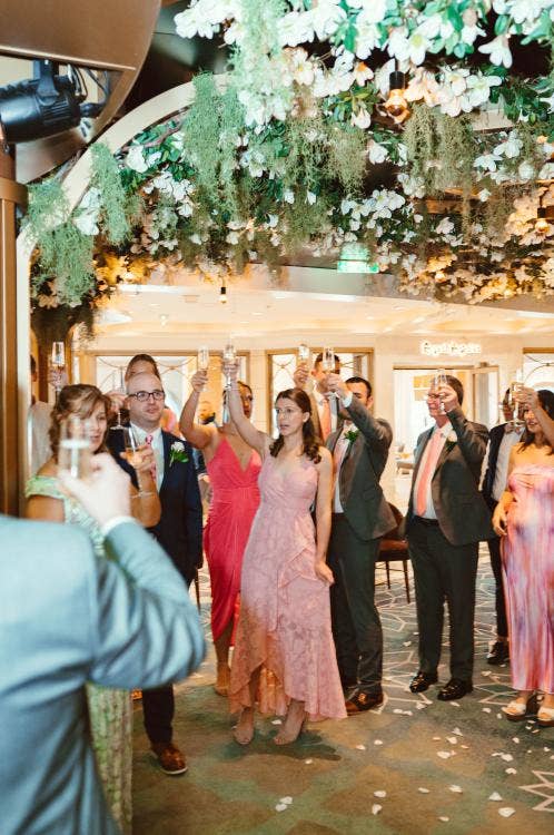 guests, cheers, toast, wedding reception, reception, the bayou, Disney Wish, Disney cruise line, cruise wedding