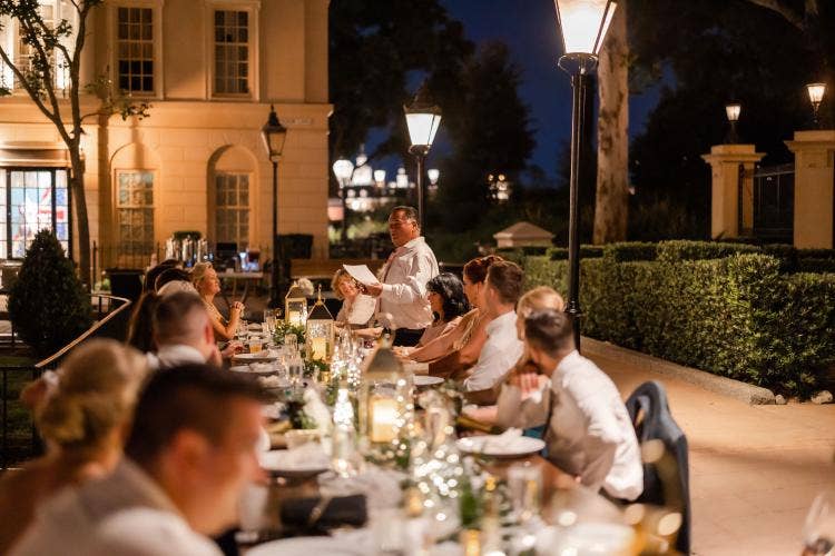 wedding reception, reception, decorated reception, long table, custom chairs, table runner, custom centerpieces, reception decor, lanterns, table decor, Epcot, Epcot reception, uk, uk pavilion, uk courtyard