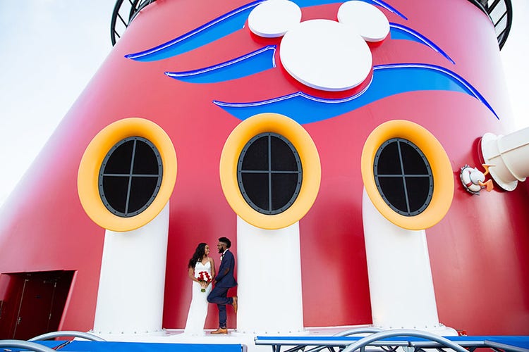 A man and woman on the top deck of the Disney Cruise Line