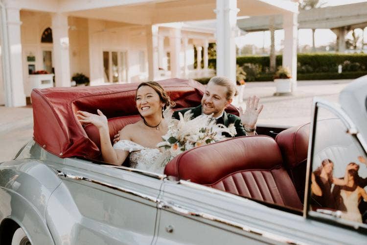 bride and groom, couple, portrait, staged exit, exit, transportation, vintage car, car, motorcar, boho floral, floral