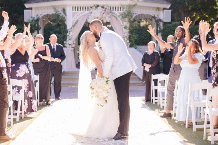bride and groom, couple, wedding ceremony, ceremony, exit, ceremony exit, kiss, Disneyland, Disneyland Hotel, rose court, rose court garden