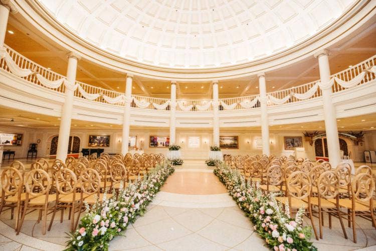 decorated wedding ceremony, wedding ceremony, ceremony, venue, epcot, aa rotunda, america pavilion, america adventure rotunda, custom chairs, aisle floral, custom aisle floral, boho, boho floral