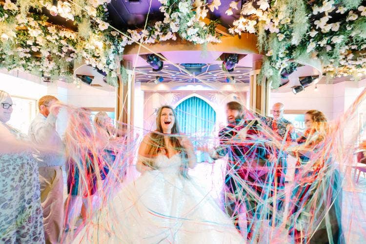 bride and groom, couple, entrance, wedding reception, reception, reception entrance, streamers, disney cruise line, cruise, cruise line, disney cruise, disney wish, the bayou
