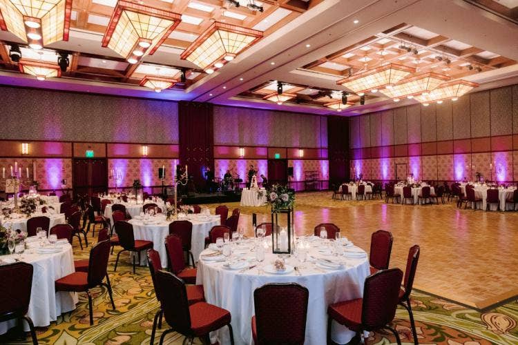 decorated wedding reception, reception, wedding reception, reception decor, venue shot, ballroom reception, ballroom, custom up lighting, up lighting, purple up lighting, moody aesthetic, halloween, halloween theme