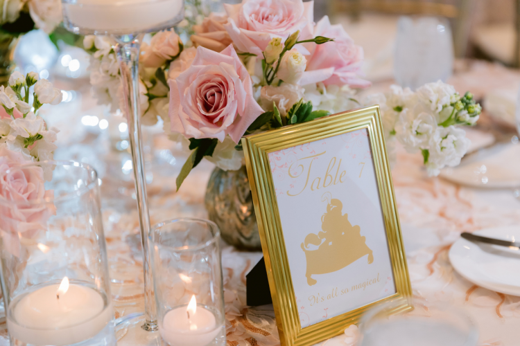 wedding reception, reception, decor, reception decor, table decor, centerpieces, pink floral, floral, pink roses, floating candles, princess, princess theme, princess table names, table names, sleeping beauty pavilion, disneyland, disneyland hotel