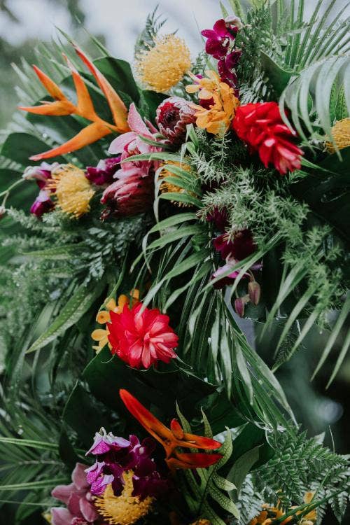 wedding ceremony, ceremony, floral, ceremony floral, tropical, tropical floral, colorful floral, palm fronds, aulani, halawai lawn