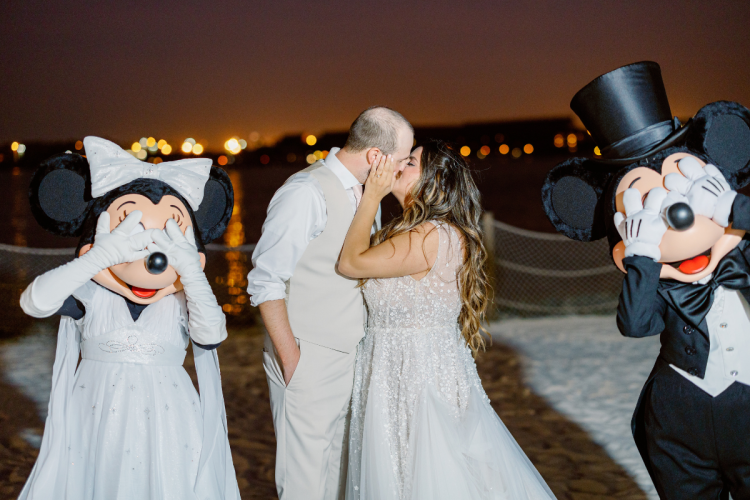 bride and groom, couple, cutting cake, wedding cake, cake, mickey and minnie, characters, entertainment, wedding reception, reception, summerhouse patio, grand floridian