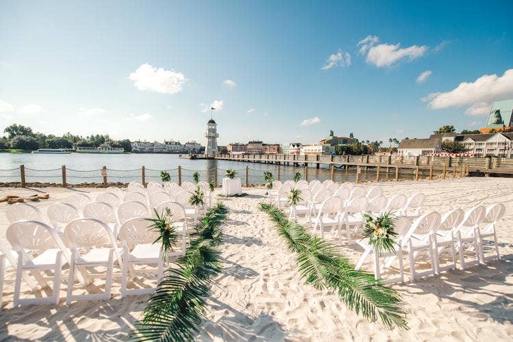 decorated wedding ceremony, wedding ceremony, ceremony, crescent cove, beach, beach wedding, palm fronds, tropical floral, aisle floral