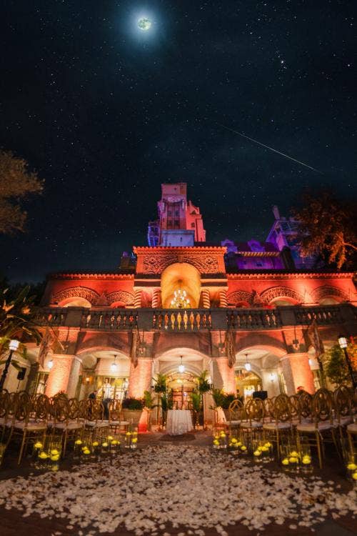 wedding ceremony, ceremony, ceremony decor, ceremony floral, up lighting, custom up lighting, aisle floral, nighttime, hollywood studios, tower of terror, tower of terror courtyard, tower of terror ceremony