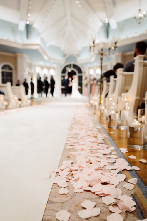 wedding ceremony, ceremony, decorated wedding ceremony, pink floral, floral, aisle, aisle floral, petal toss, pink petal toss, disney's wedding pavilion, wedding pavilion, pavilion, nighttime ceremony