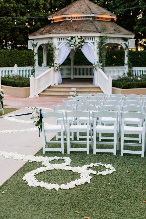 decorated wedding ceremony, wedding ceremony, ceremony, aisle floral, custom aisle floral, hidden mickey, floral hidden mickey, white floral, disneyland, Disneyland Hotel, rose court, rose court garden, gazebo, cinderella-inspired