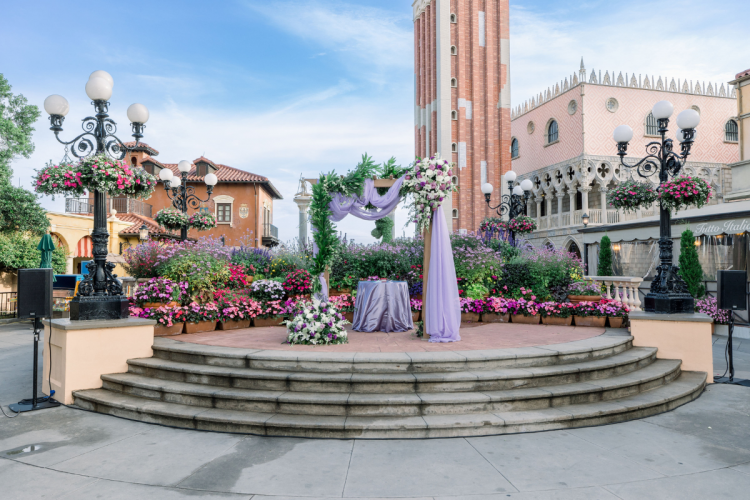 wedding ceremony, ceremony, ceremony decor, ceremony floral, altar, altar area, altar floral, epcot, italy, italy pavilion, italy plaza, purple, purple floral