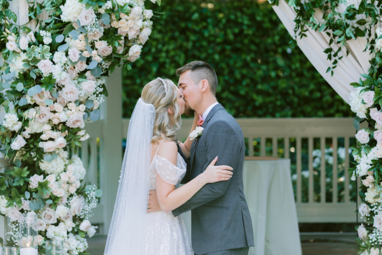 bride and groom, couple, first kiss, wedding ceremony, ceremony, ceremony kiss, kiss, rose court, rose court garden, disneyland, disneyland hotel