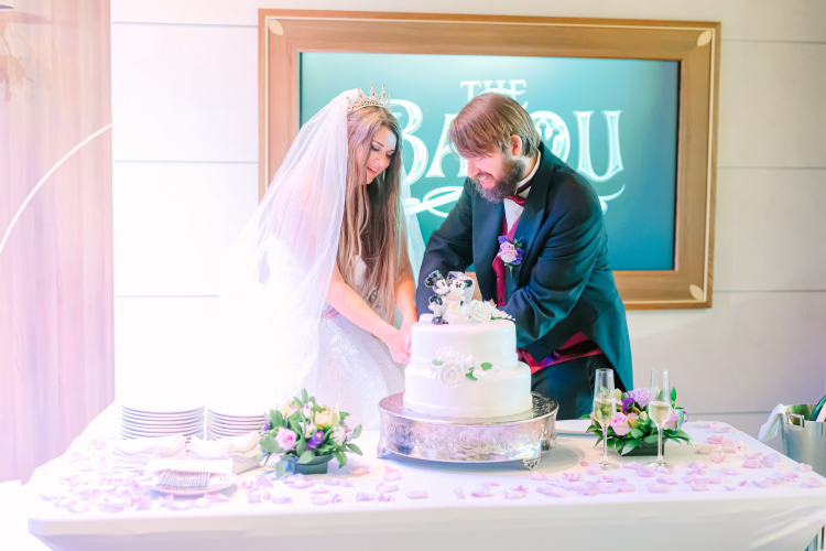 bride and groom, couple, wedding reception, reception, cutting cake, disney cruise line, cruise line, disney cruise, cruise, disney wish, the bayou, disney wish the bayou