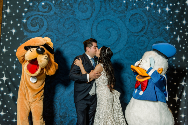 bride and groom, couple, wedding reception, reception, characters, disney characters, meet and greet, character meet and greet, pluto, donald duck, kiss, couple kiss, living seas, living seas salon, epcot