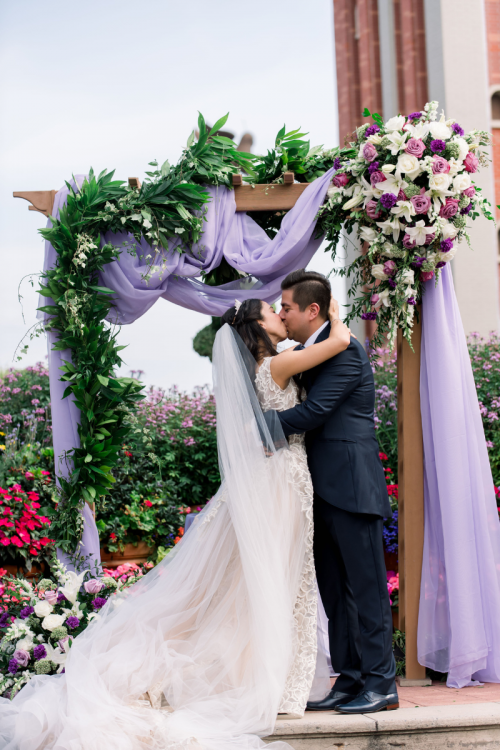bride and groom, couple, wedding ceremony, ceremony, altar area, altar, candid, vows, epcot, italy, italy pavilion, italy plaza, first kiss