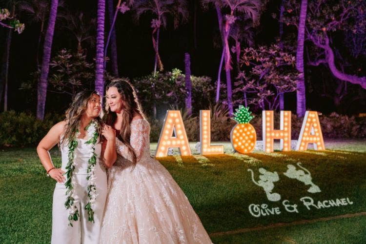 couple, portrait, couple portrait, wedding reception, reception, Aulani, Hawaii, lanikuhonua, LGBTQ, bride bride, lighted letters, aloha sign, aloha letters, gobo, custom gobo