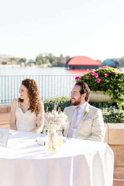 couple, sweetheart table, reception, wedding reception, Epcot, terrace des fleurs, France Pavilion