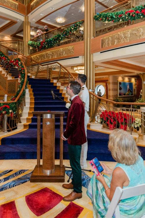 groom, candid, wedding ceremony, ceremony, entrance, bridal entrance, disney cruise line, cruise line, disney cruise, cruise, cruise wedding, disney dream, atrium, christmas, christmas decor, holiday, holiday decor, christmas cruise, christmas wedding