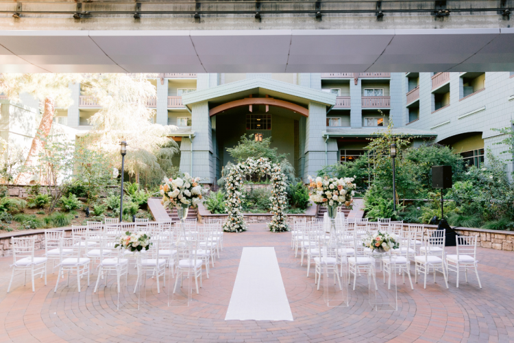 venue shot, brisa courtyard, grand californian, floral, floral altar, altar decor, altar, altar decor, aisle runner, chiaviari chairs, custom chairs
