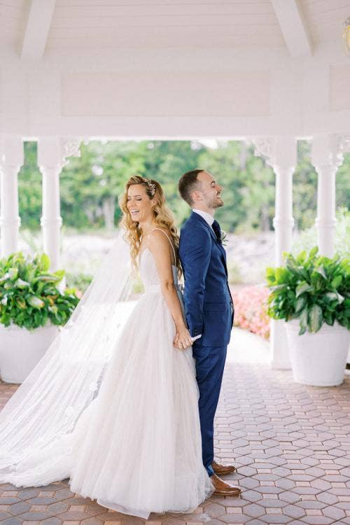 bride and groom, couple, first touch, Disney's wedding pavilion, wedding pavilion