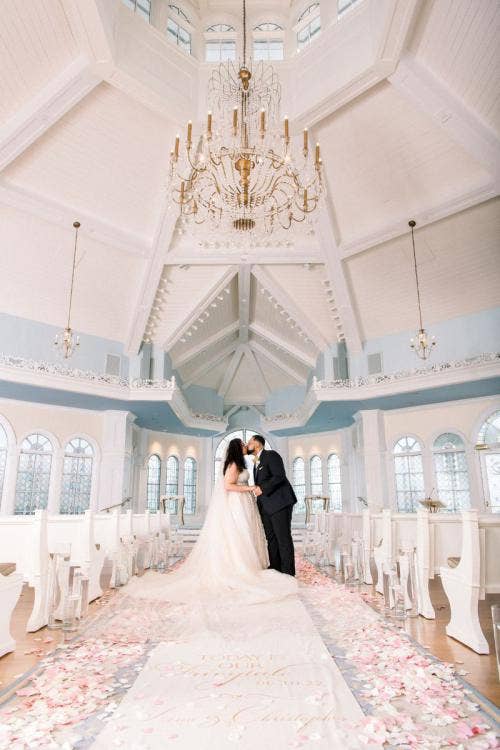 bride and groom, couple, portrait, couple portrait, wedding pavilion, disney's wedding pavilion, pink floral, floral, aisle floral, aisle decor, aisle runner, custom aisle runner, ceremony, wedding ceremony, diversity