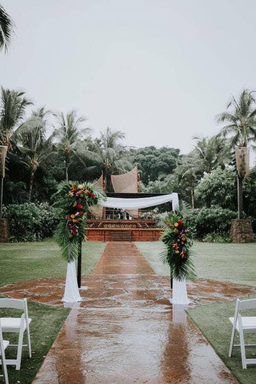 wedding ceremony, ceremony, ceremony decor, ceremony floral, altar area, altar floral, tropical, tropical floral, palm fronds, colorful floral, white drape, altar arch, floral arch, aulani, aulani wedding, aulani ceremony, halawai lawn, halawai