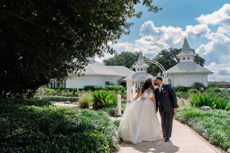 bride and groom, couple, portrait, couple portrait, staged exit, wedding pavilion, disney's wedding pavilion, wedding pavilion gate, wedding ceremony, ceremony, diversity