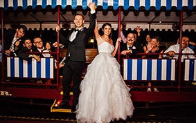 Bride and groom ride with guests on the Disneyland Train during wedding reception