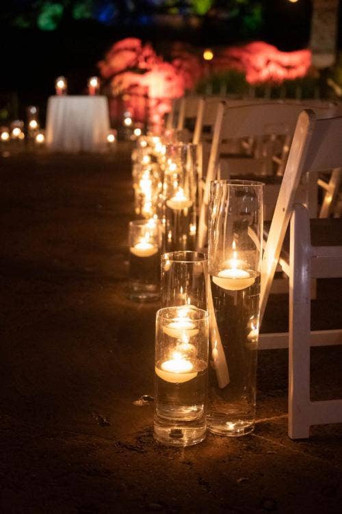 wedding ceremony, ceremony, decor, ceremony decor, aisle, aisle decor, aisle candles, floating candles, disney's animal kingdom, animal kingdom, tree of life, tree of life ceremony