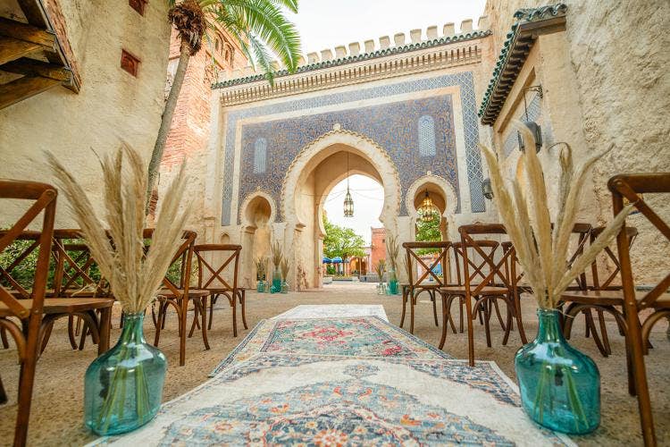 decorated wedding ceremony venue, wedding ceremony, ceremony, ceremony venue, decorated venue, epcot, morocco, morocco pavilion, custom aisle runner, aisle, aisle decor, custom aisle decor, custom chairs