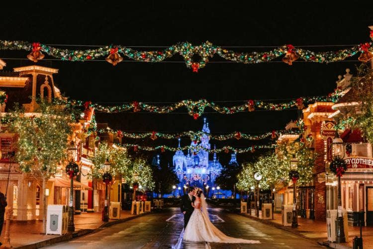 bride and groom, couple, portrait, couple portrait, park portrait, Disneyland, Disneyland Park, christmas, christmas decor, holiday, Christmastime, sleeping beauty castle, Main Street