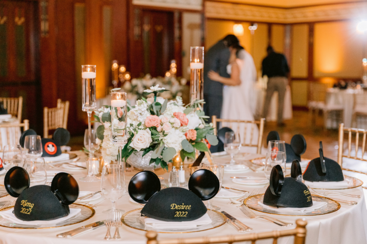 venue shot, decorated venue, wedding reception, reception, table rounds, custom chairs, chiavari chairs, wedding favors, mickey hats, uplighting, custom uplighting, reception decor, custom centerpieces, table centerpieces
