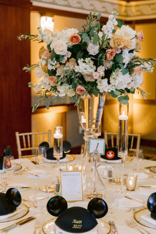 venue shot, decorated venue, wedding reception, reception, table rounds, custom chairs, chiavari chairs, wedding favors, mickey hats, uplighting, custom uplighting, reception decor, custom centerpieces, table centerpieces, floral centerpieces