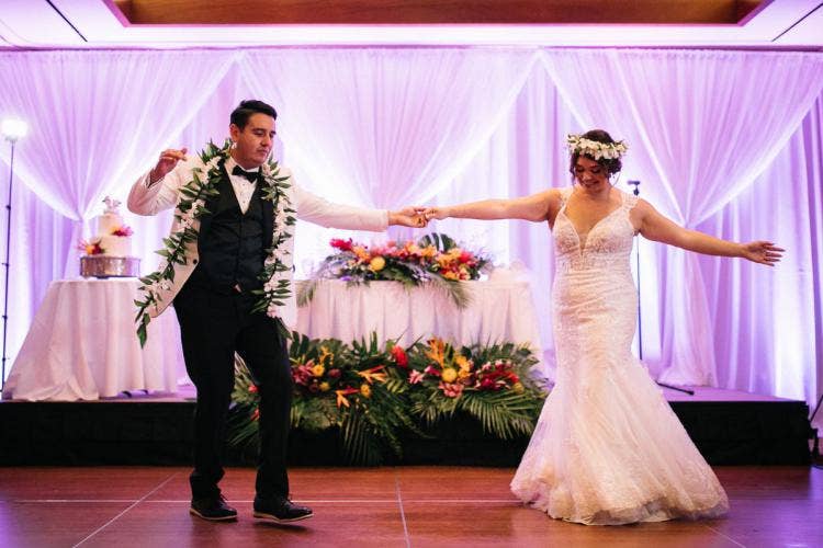 bride and groom, couple, first dance, wedding reception, reception, custom up lighting, white drape, drapery wall, tropical floral, sweetheart table, floral, flower crown, lei, palm fronds, colorful floral, aulani, ka'ala ballroom, ka'ala