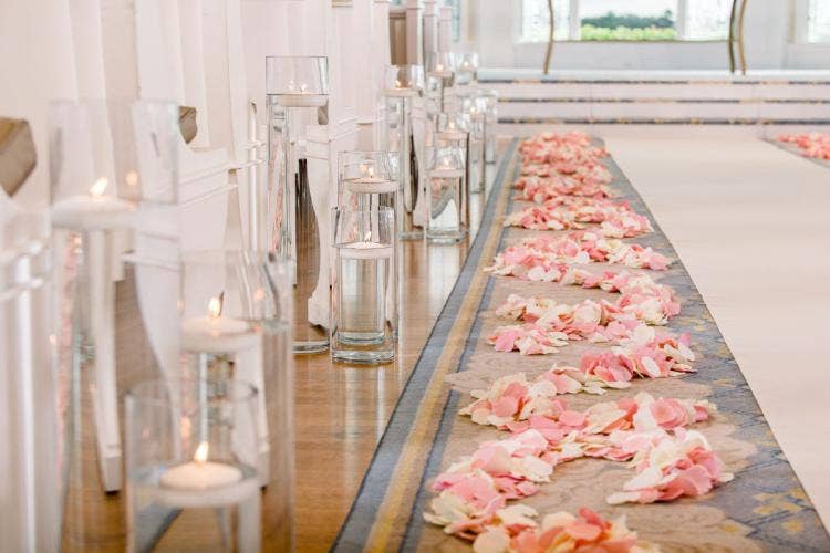 wedding ceremony, ceremony, ceremony decor, ceremony floral, aisle decor, aisle floral, custom aisle floral, pink floral, pink petals, floating candles, aisle floating candles, disney's wedding pavilion, wedding pavilion