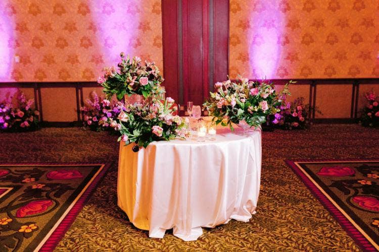 wedding reception, reception, decor, reception decor, sweetheart table, moody aesthetic, moody floral, custom up lighting, up lighting, purple up lighting, grand californian, grand californian ballroom