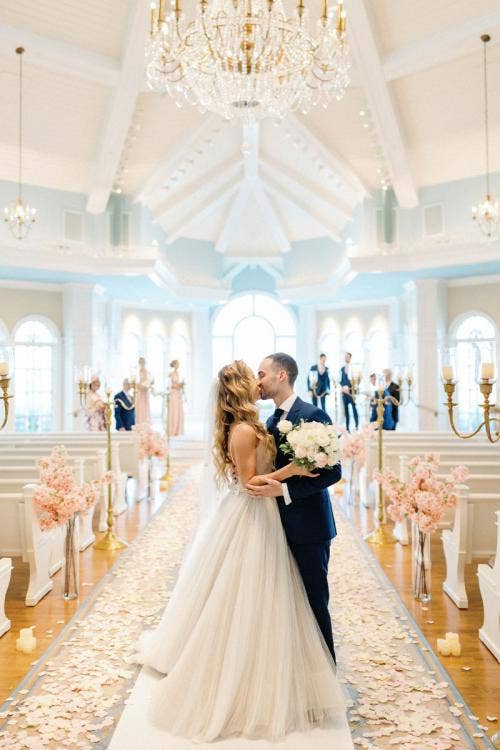 bride and groom, couple, exit, wedding ceremony, ceremony, kiss, Disney's wedding pavilion, wedding pavilion, custom aisle decor, aisle floral, pink floral