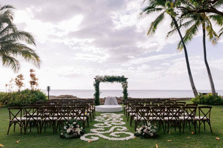 decorated wedding ceremony, ceremony, wedding ceremony, altar floral, altar arch, palm fronds, custom chairs, aisle floral, floral designs, custom aisle floral, custom floral design