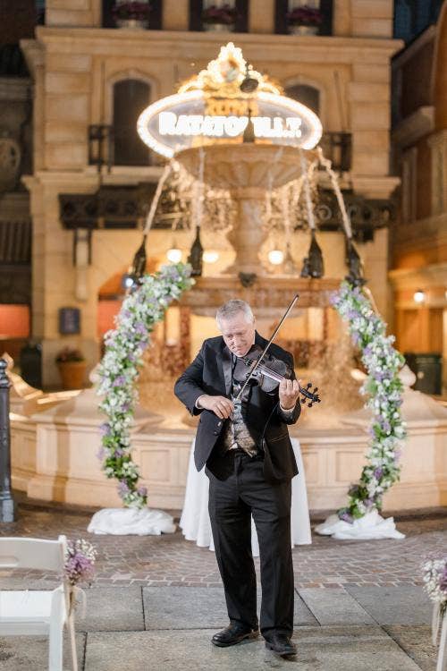 wedding ceremony, venue, ceremony venue, decorated ceremony, Epcot, france pavilion, place de Remy, altar area, musician, entertainment, violinist