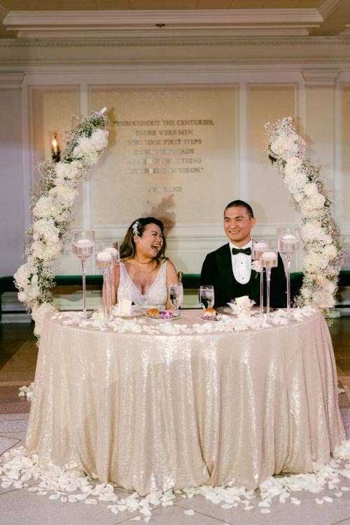 bride and groom, couple, sweetheart table, reception, wedding reception, floral arch, white floral, reception decor, table decor, Epcot, aa rotunda, American adventure rotunda, America pavilion