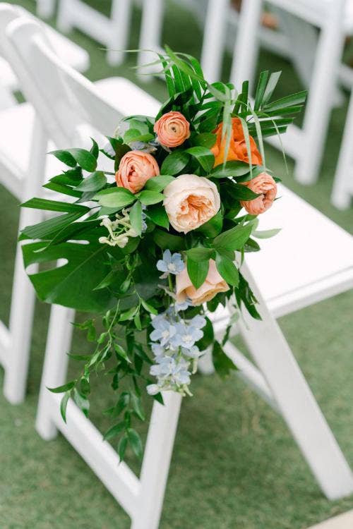wedding ceremony, ceremony, aisle, aisle decor, aisle floral, tropical floral, colorful floral, palm fronds, disneyland, disneyland hotel, rose court, rose court garden