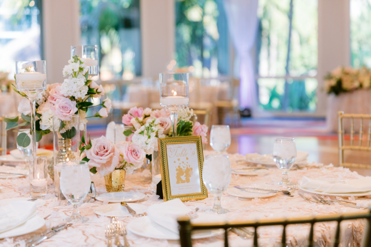 wedding reception, reception, decor, reception decor, table decor, centerpieces, pink floral, floral, pink roses, floating candles, princess, princess theme, princess table names, table names, sleeping beauty pavilion, disneyland, disneyland hotel
