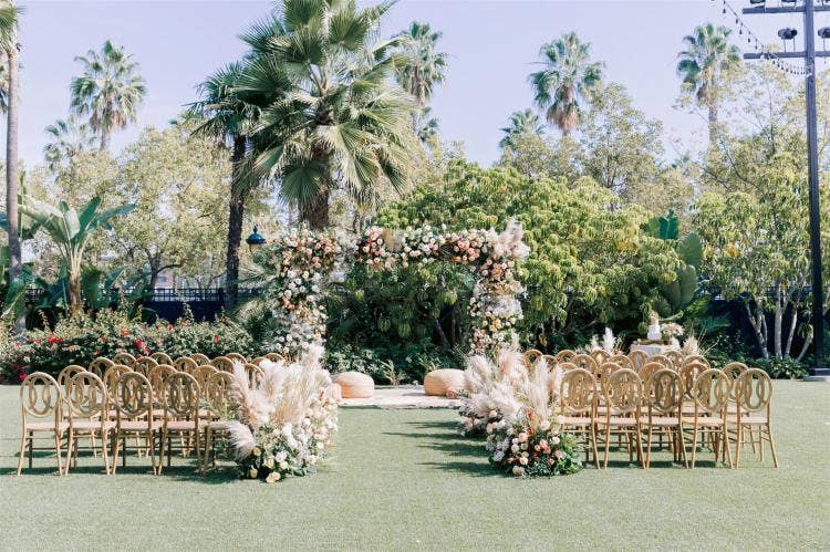decorated wedding ceremony, wedding ceremony, ceremony, altar floral, altar arch, floral arch, aisle floral, boho, boho floral, custom chairs, indian wedding