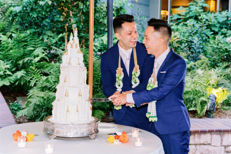 lgbtq, lgbtq couple, groom, groom groom, thai wedding, thai outfits, wedding cake, cutting cake, wedding cake with castle cake topper, cake topper, brisa courtyard, disneyland