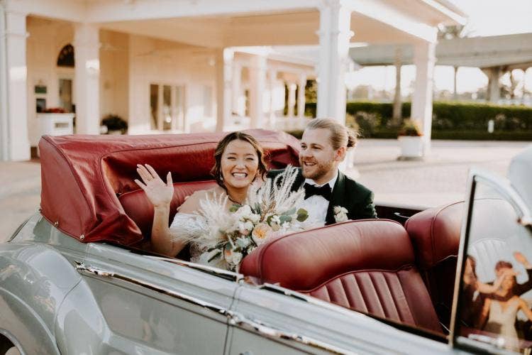 couple, exit, staged exit, vintage car, car, modern, trendy, wedding pavilion, Disney's wedding pavilion, couple, Disney world, Walt Disney World